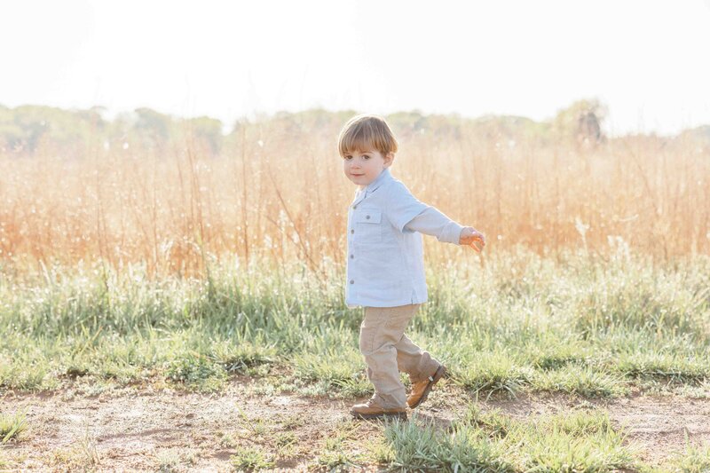 Boy walking in field during Loudoun County, VA session