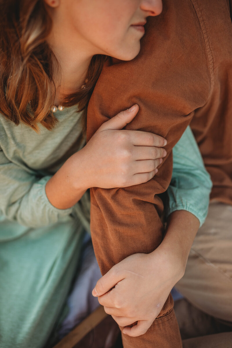 A girl hugging her father's arm at Pipestem State Park, in West Virginia. 