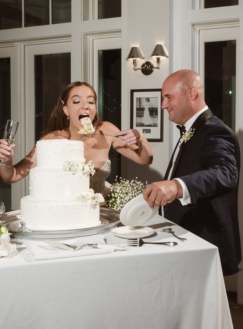 funny cake cut moment of the bride and groom