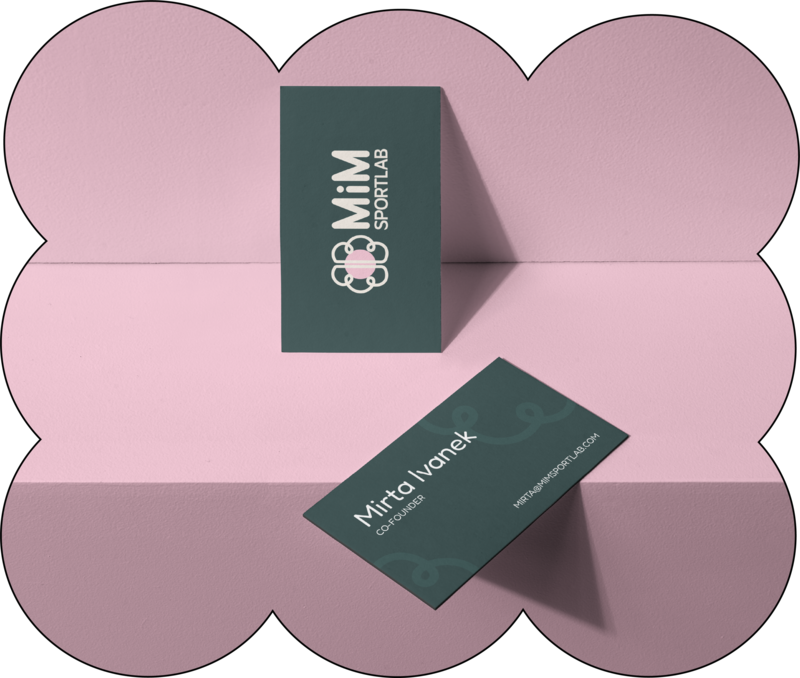Business card mockup. Card is dark green, background is pink