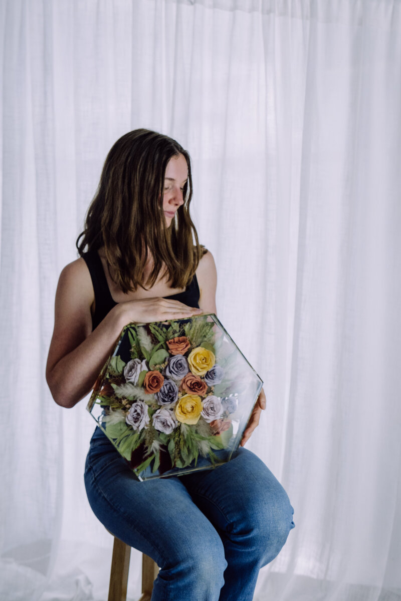 colorful resin bouquet preservation hexagon block held by the professional artist