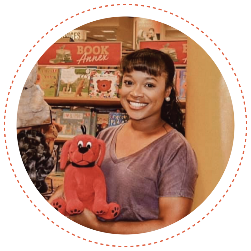 miss erica holding clifford stuffed animal with bookshelf