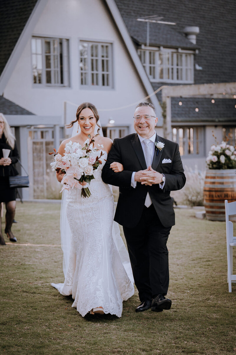 Bride walking down the aisle with her very proud dad 