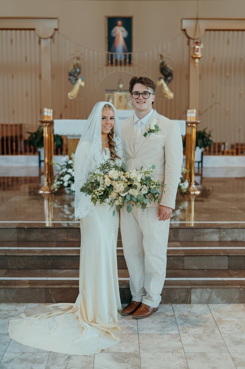 a Catholic couple posing for a wedding portrait