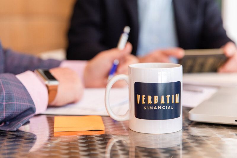 detail branded mug with man taking notes in the background during a meeting in GA by Laure Photography