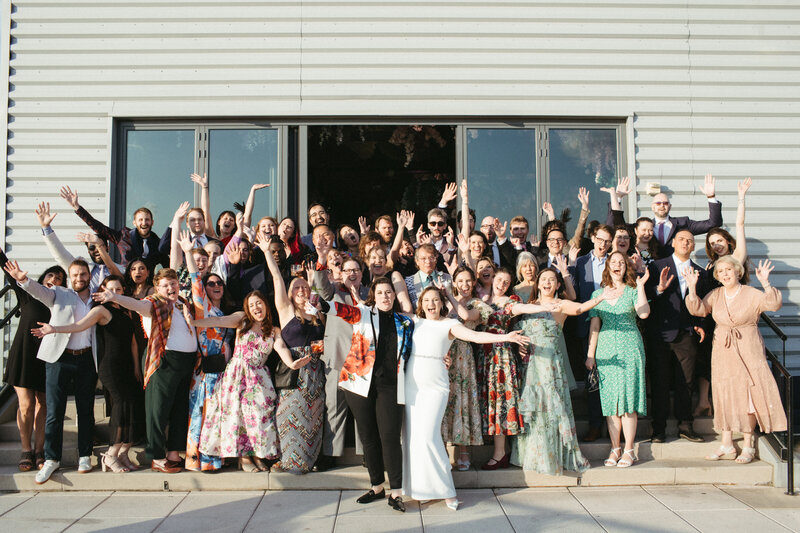 wedding guest group portrait of wedding guests and lesbian brides all celebrating for the camera