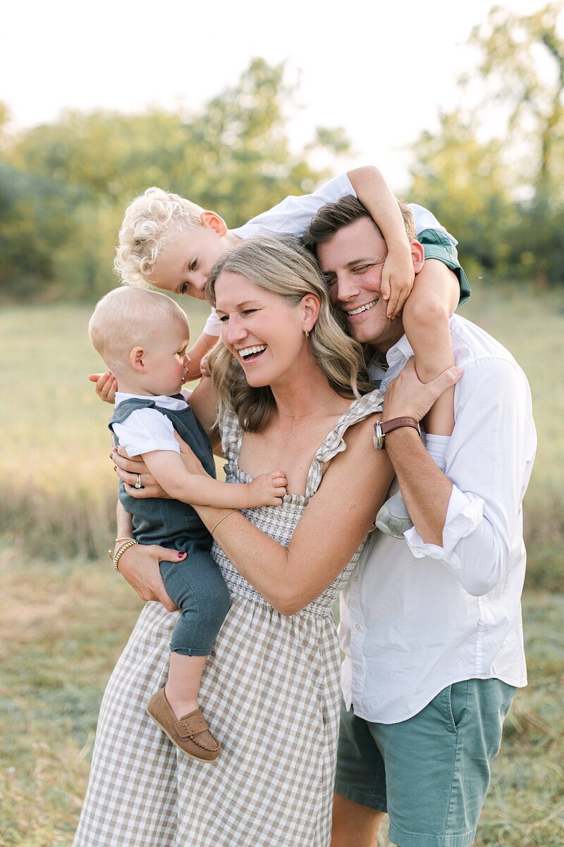 family in Delafield wisconsin smiling at the youngest boy being held by his mom