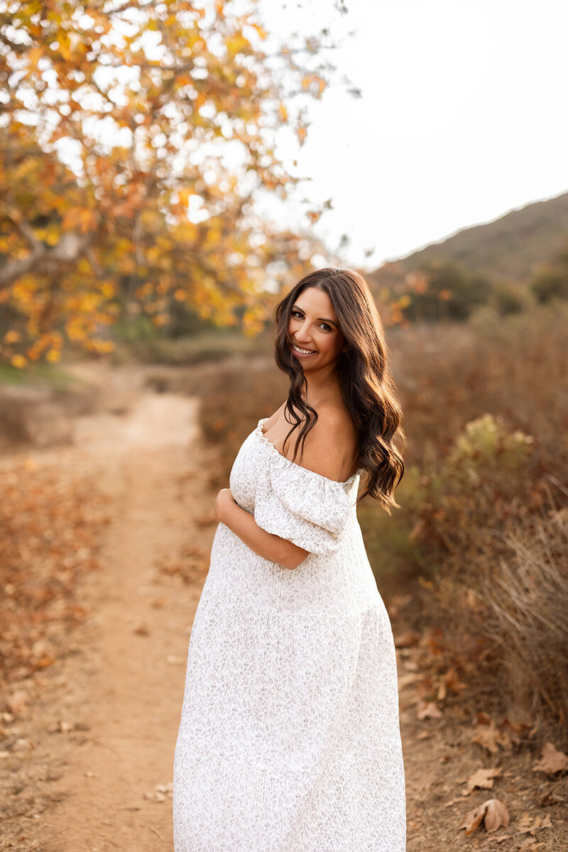girl in field, rylee and cru clothing, looking at camera, windblown hair