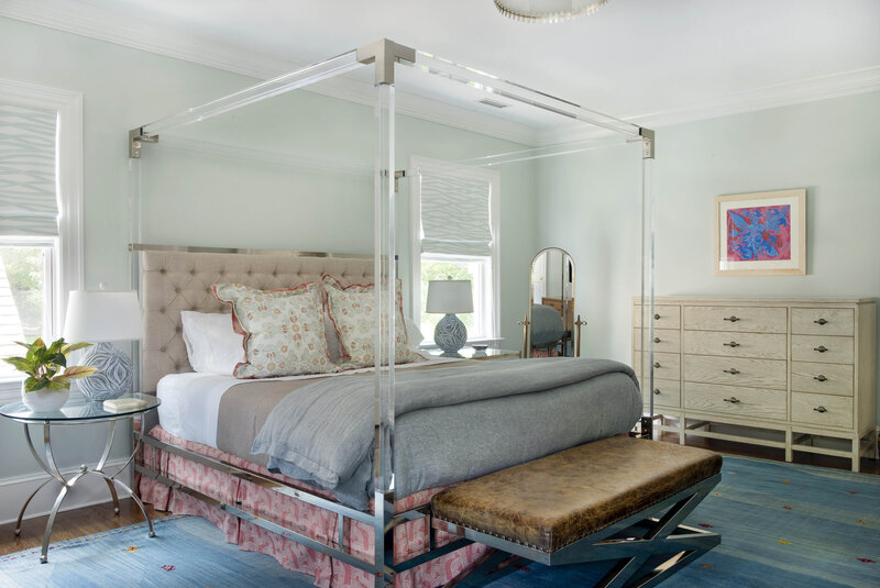 Bedroom interior with acrylic 4 poster bed and tufted headboard