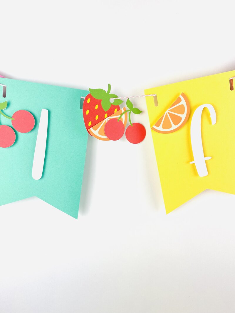 Close up tutti fruiti handmade banner with strawberries and oranges and cherries