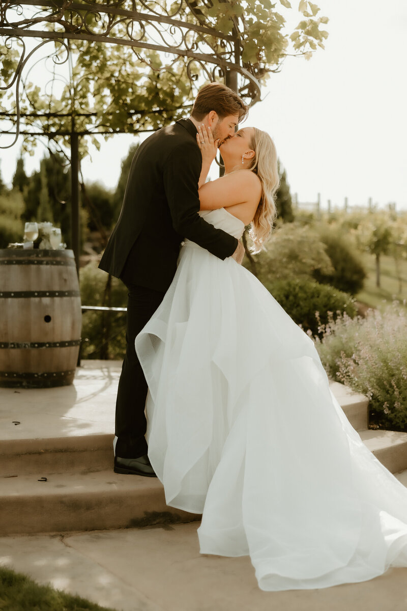 Bride and Groom kiss at the alter at Folino Estate for their luxury wedding photographer in Kutztown PA