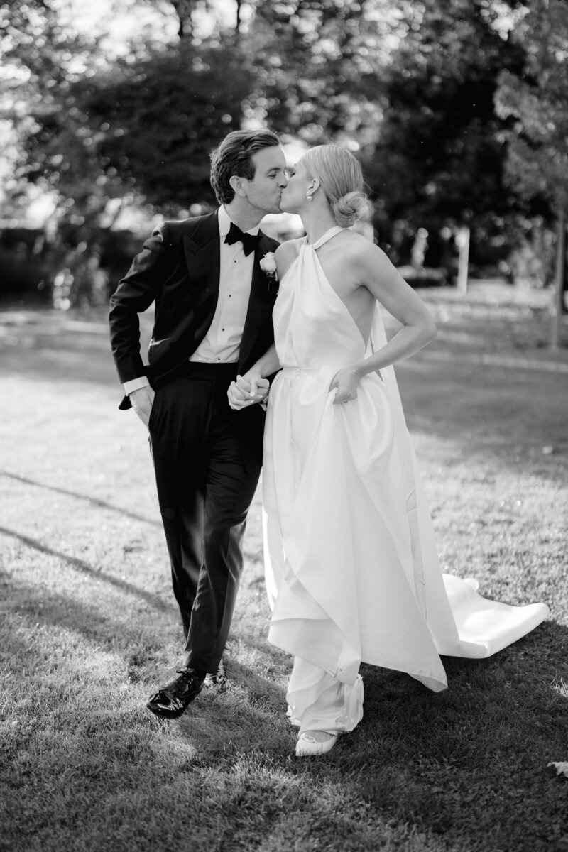 natural bride and groom  wedding photo of couple walking wearing black tie