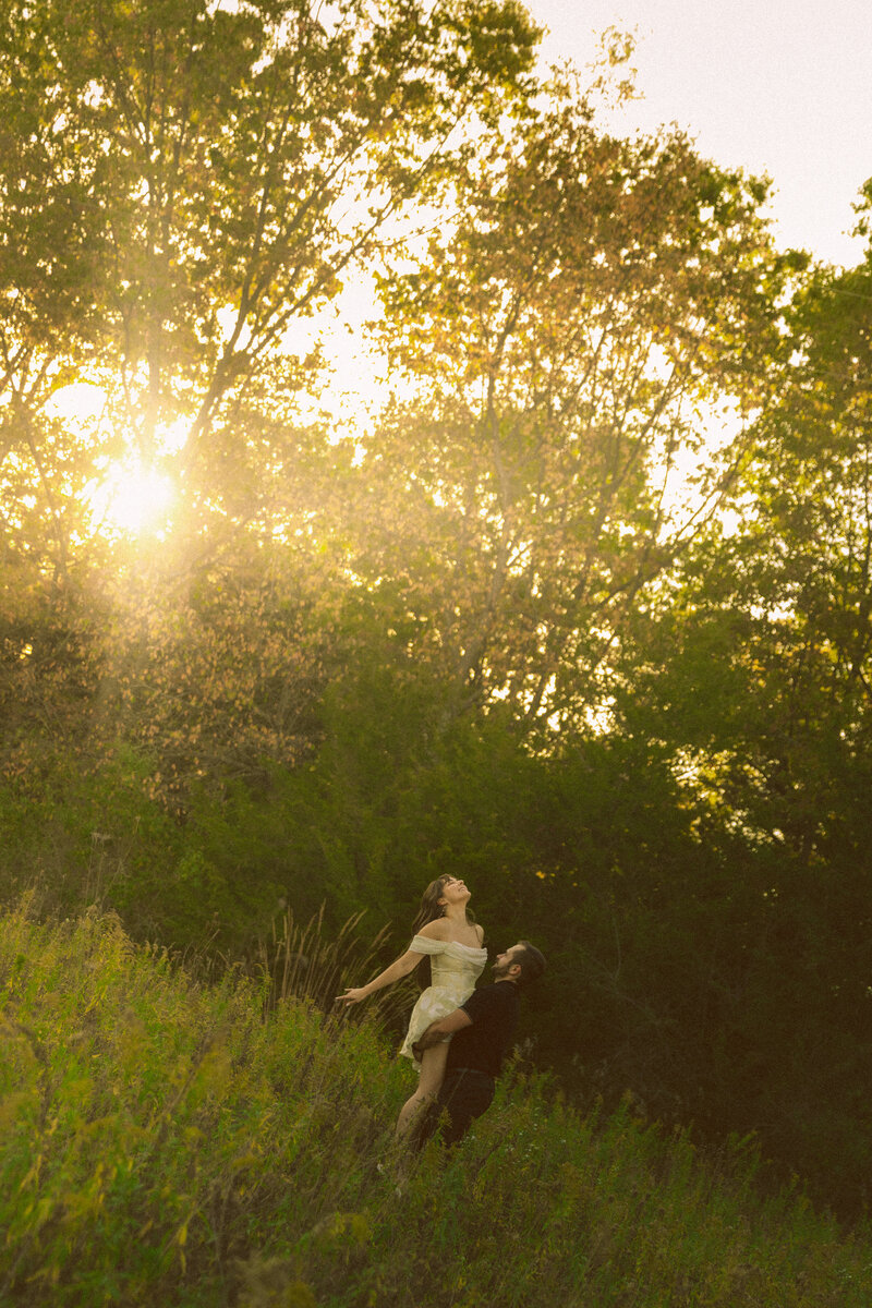 A photographer looks through her camera to take a photo