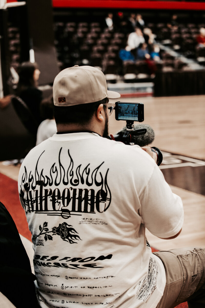 Photo of Videographer shooting college sports