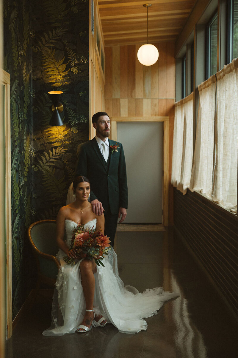 Bride at stone wall in her garden wedding