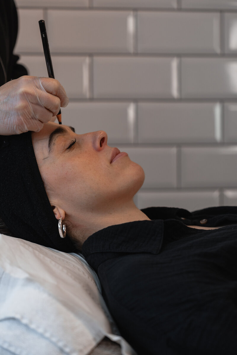 photo of woman getting semi permanent makeup on her eyebrows in dublin