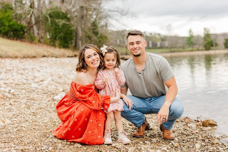parents posing with their toddler