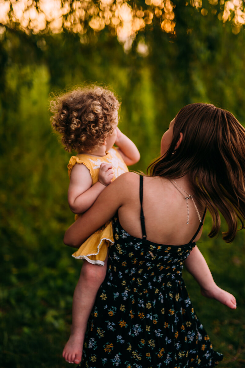 girls under a willow tree at sunset