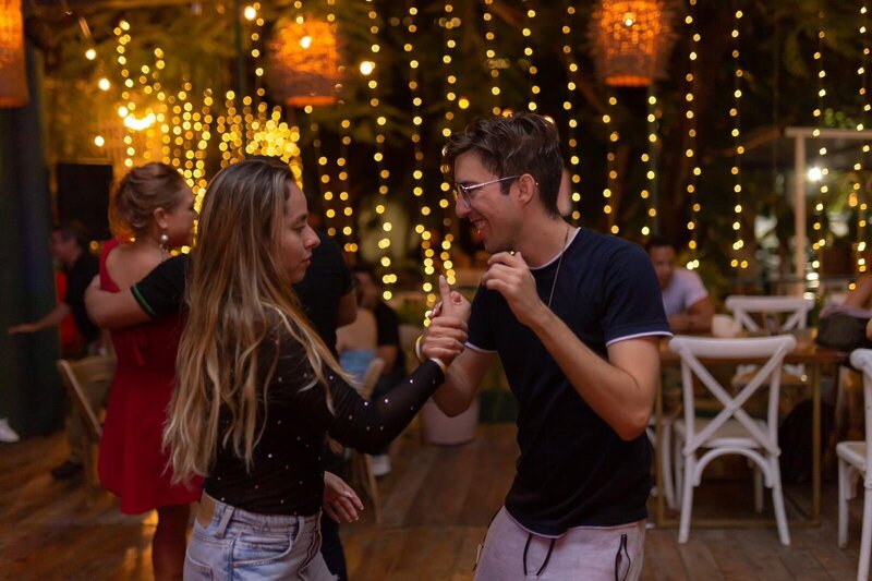 Chris dancing salsa with guests at a Cancun wedding.