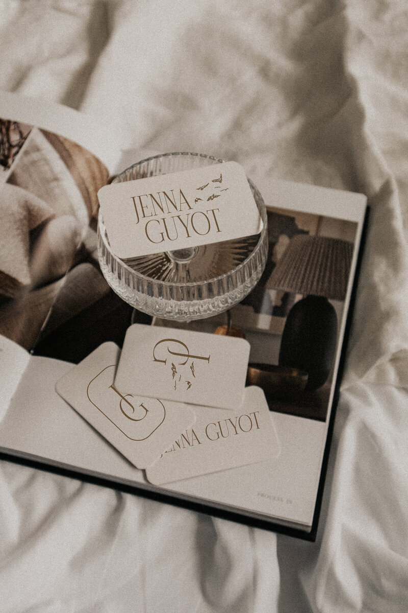 champagne glass and book on bed