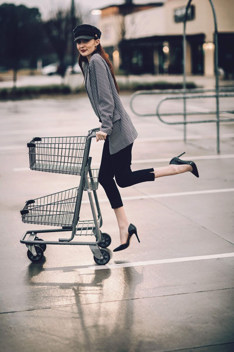 A woman pushing a shopping cart in a parking lot captured by Shreveport portrait photographer Britt Elizabeth.