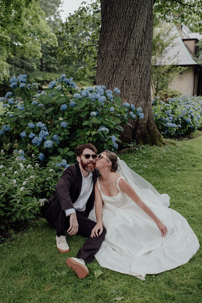 Bride and groom kissing in a park, summer wedding in Connecticut