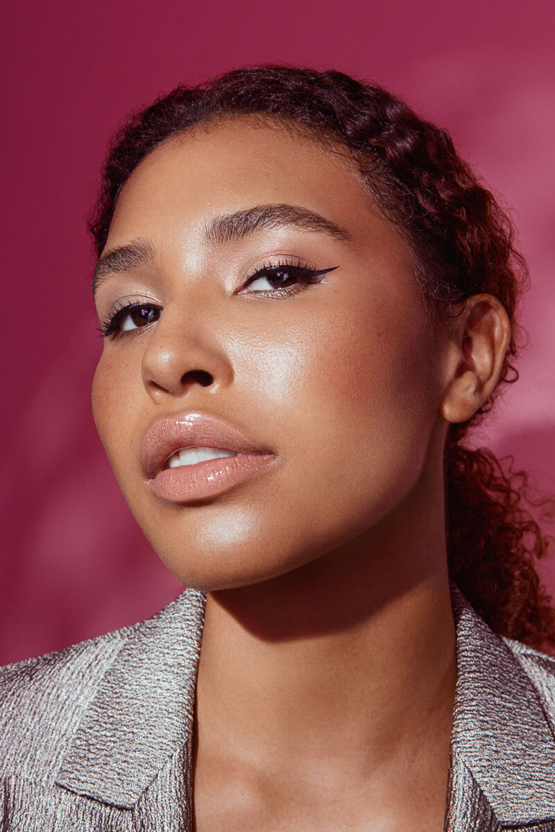 Portrait of Jazz Walters with minimal makeup and natural curly hair, captured by Ylva Erevall in soft lighting.
