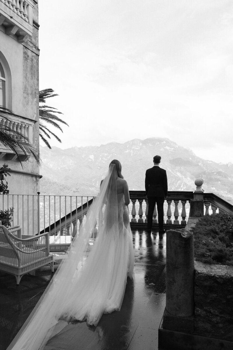 black and white editorial photo of wedding couple on balcony