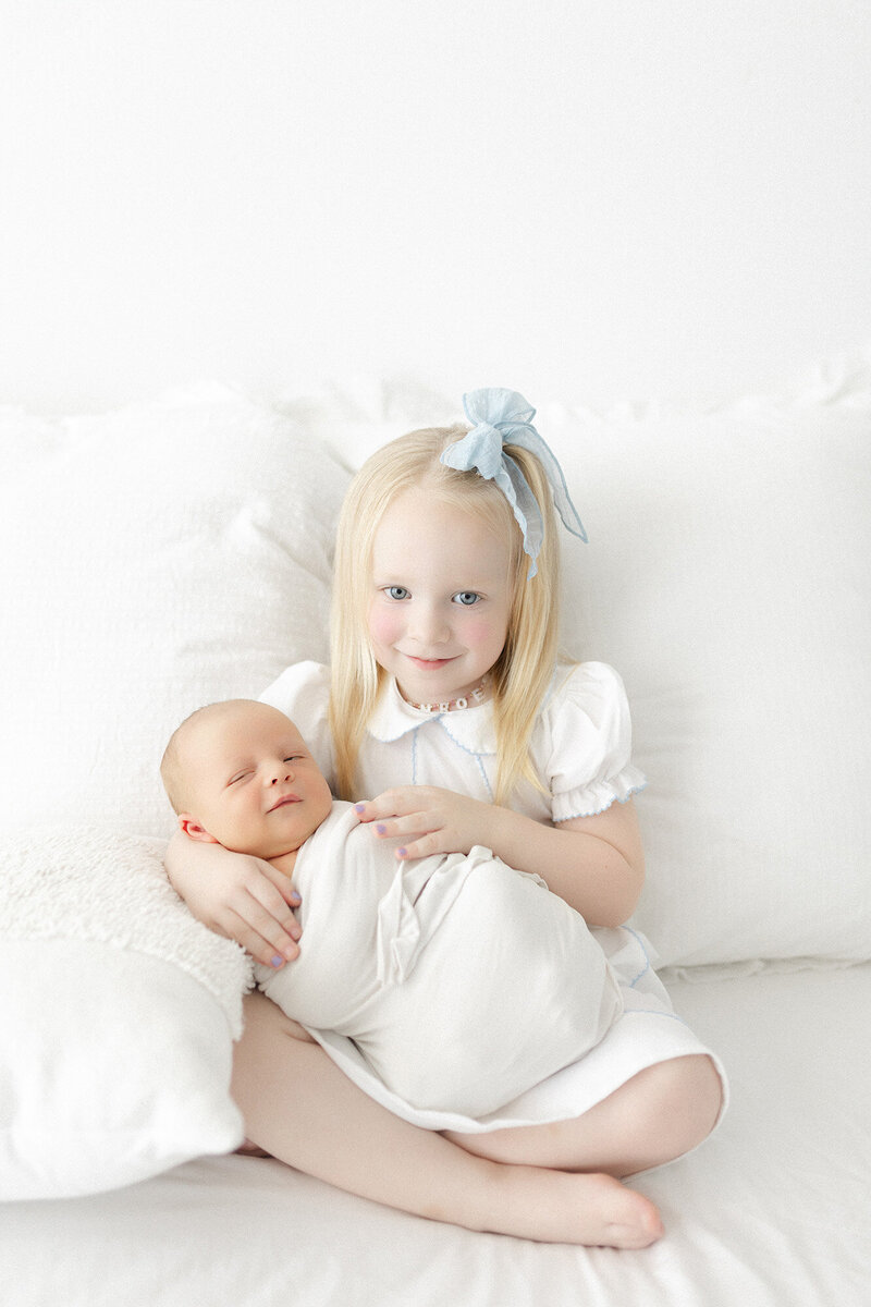 A baby boy wrapped in a cream blanket during his in-home newborn photo session in Grand Forks, ND.