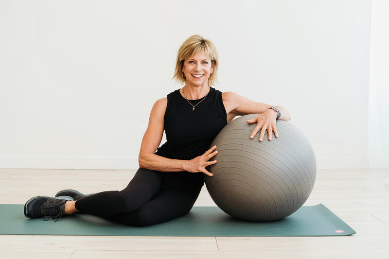 Sue Karthaiser illustrating yoga and mobility exercises with a yoga ball