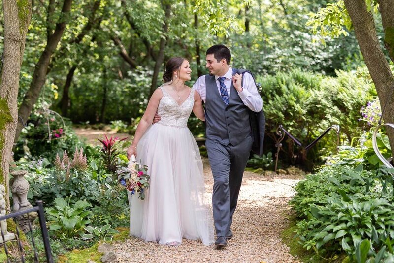Garden style wedding outdoors with bride and groom with bouquet.