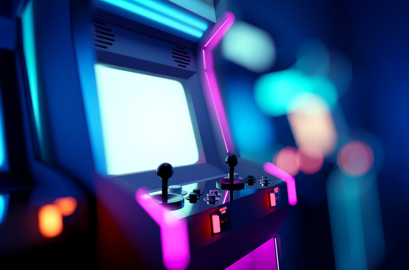 Stock photo of arcade cabinet with neon cyan and magenta lights from iStock