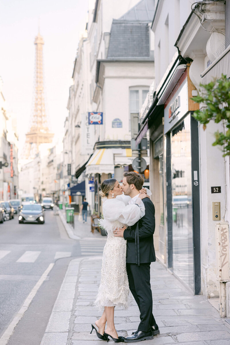 a wedding photo of the couple kissing in the streets of paris france with the eifle tower in the background