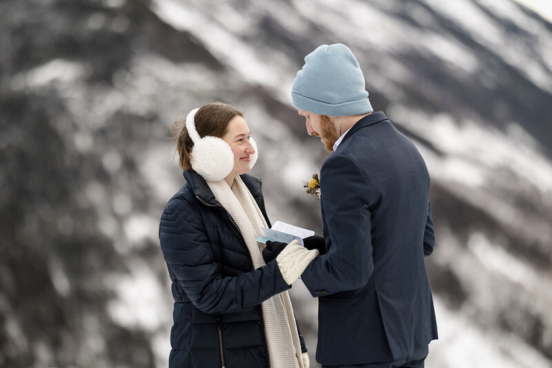 A couple standing together reading vows