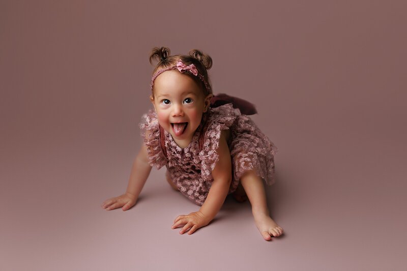 Baby making surprised face in styled milestone shoot