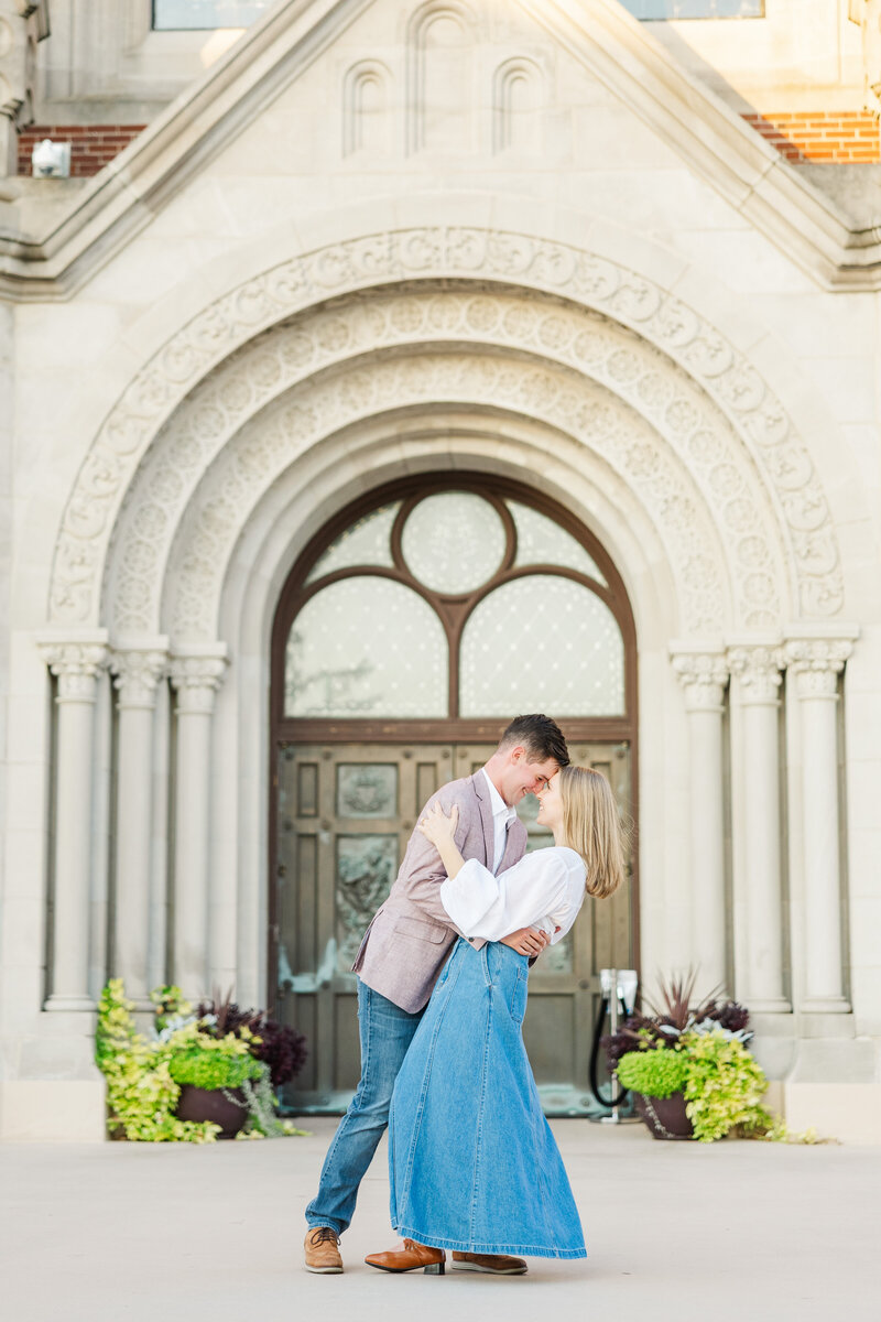 man and woman embracing in front of ornate doors