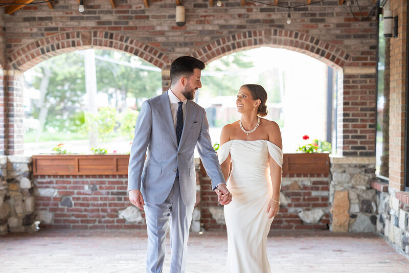 bride and groom smiling at each other lovingly at the century room at grbic events in st. lopuis