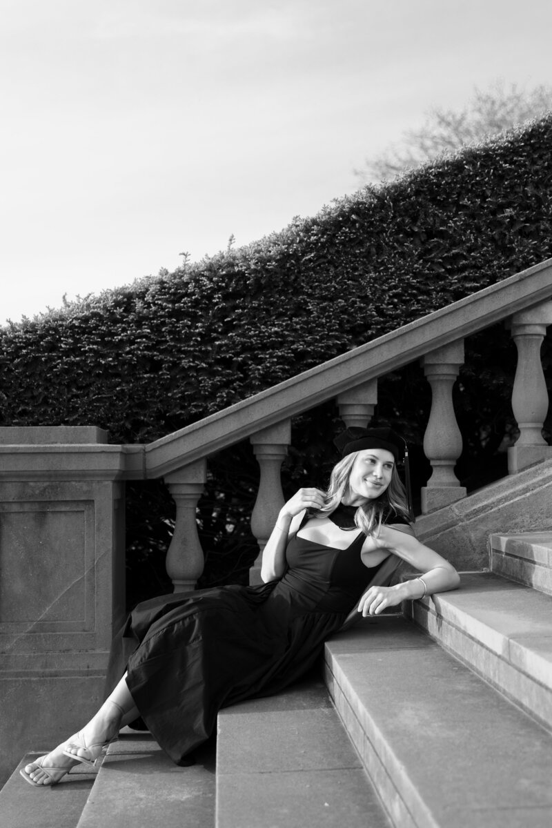 Graduate posing in cap and gown, celebrating their college graduation with joyful and proud moments captured in a timeless portrait.