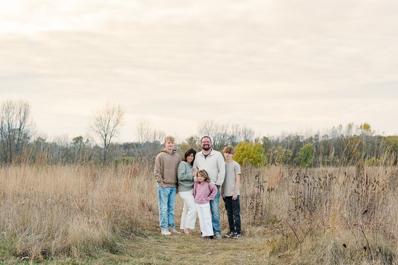 senior boy cap and gown holding tassle