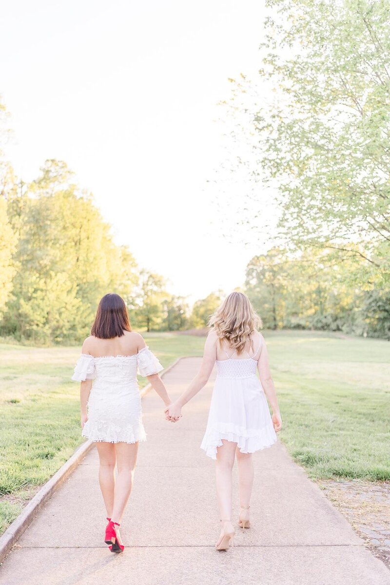 best friends holding hands while walking during their Ashburn, VA senior photos