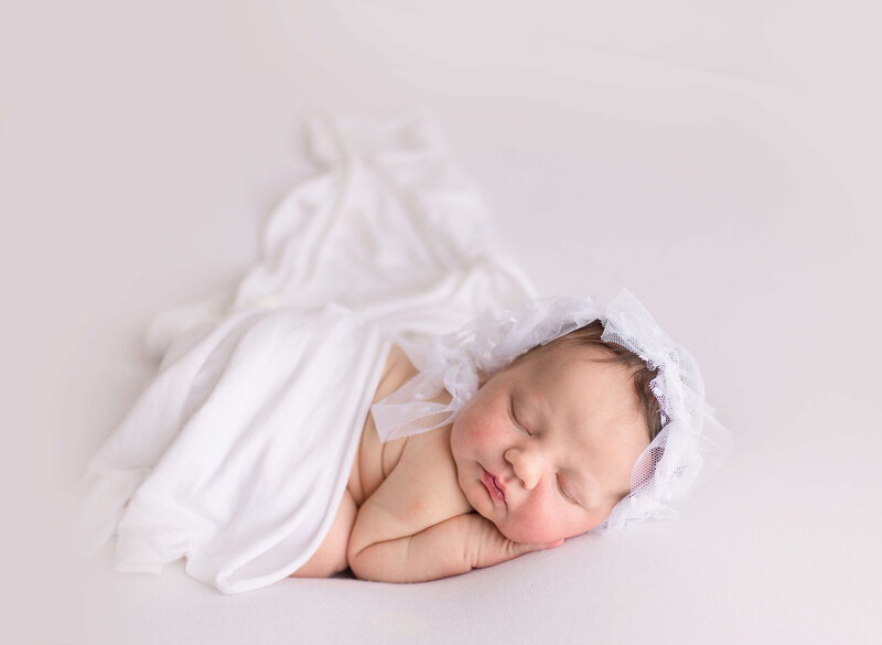infant wrapped in white