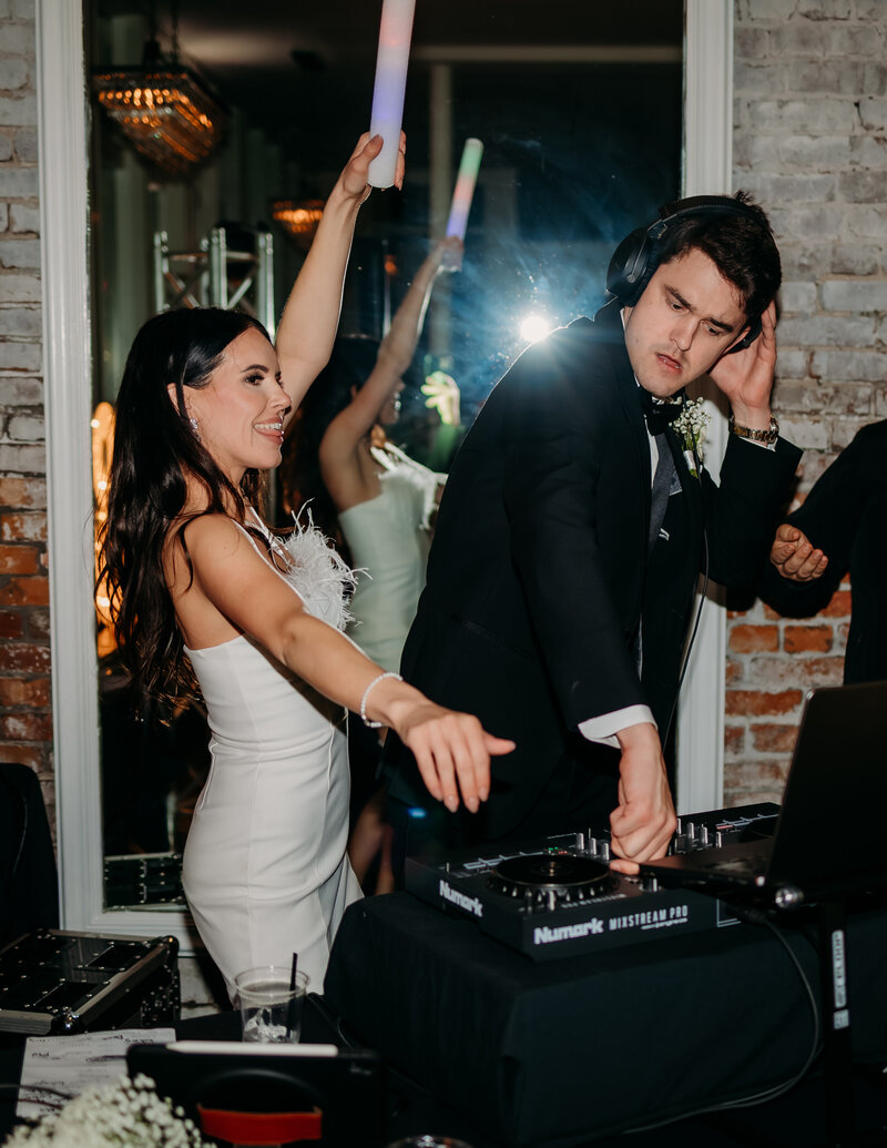 Bride and groom being the dj at their wedding reception