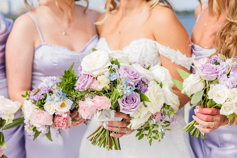 Lavender purple bridesmaid dresses and bridal florals.