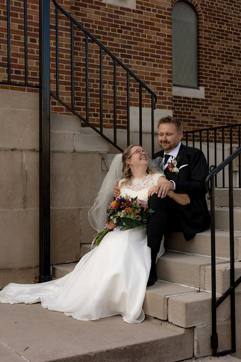 Bride and Groom share a personal moment of joy in Detroit Catholic wedding