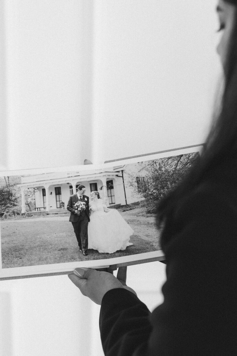 Creative self-portrait of wedding photographer Marien J Malloy with Album