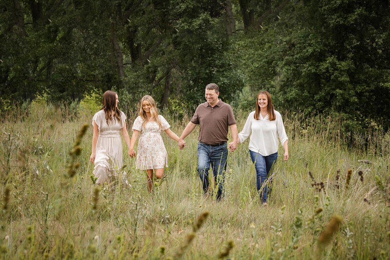 Beautiful family of four walking during their family portrait session in Southern Minnesota.