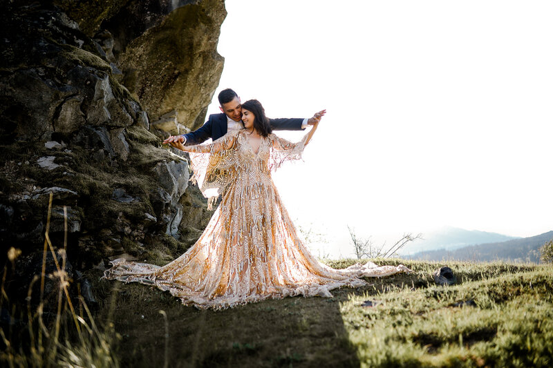 Couple sharing a romantic moment on a cliffside with stunning coastal views, captured by an Oregon Coast Elopement and Wedding Photographer.