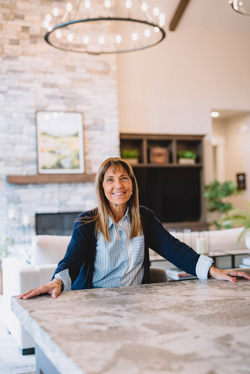 Stephanie Sarro, a Spokane interior designer and owner of Sarro Design, standing behind a kitchen counter in one of her remodeled homes.