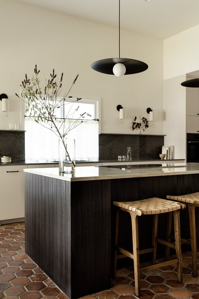 Timeless vintage cottage kitchen with antique terracotta tiles, stained oak island, and quartzite countertops by House Franc in Austin