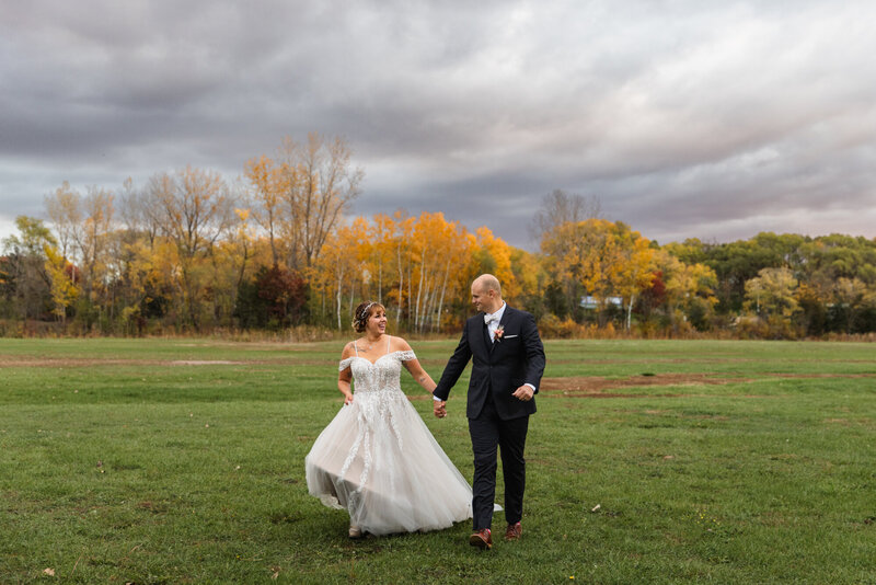 bride and groom holding hands
